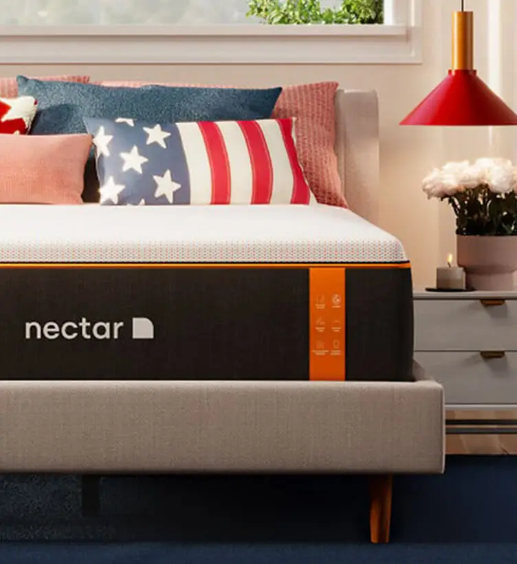 A stylish bedroom with red, white, and blue accent pillows