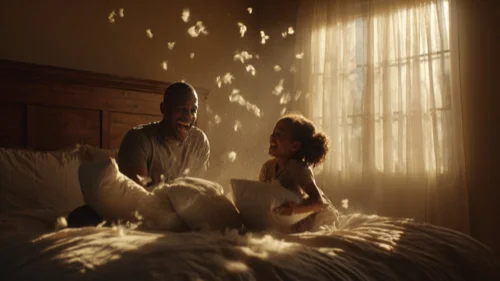 Father and daughter having a pillow fight